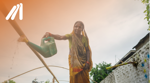 Resilience lens. A woman is watering plants. 