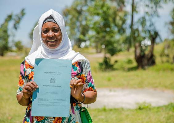 A rural woman is proudly showing her CCROs.