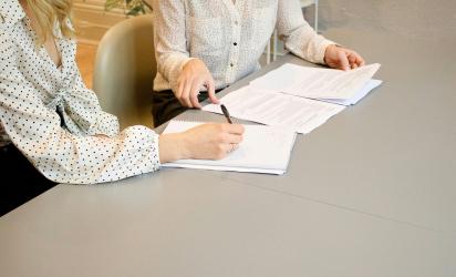 Women discussing documents. Copyright free photo