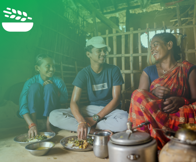 Outcome 1: Food security and nutrition. Family of three cooking food together.