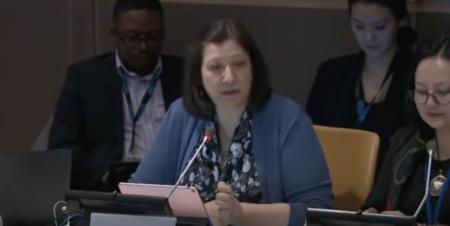 A woman speaking in a conference setting